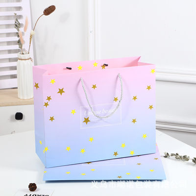 Bolso de compras impreso a medida de cartón Bolso de regalo de papel kraft blanco de lujo con mango de cinta