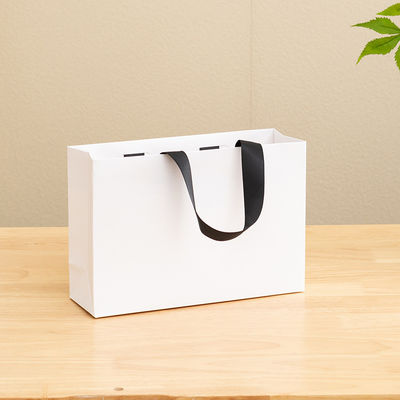 Bolsas de papel impresas personalizadas de cartón Bolsa de regalo de lujo de papel Kraft blanco para bolsas de compras